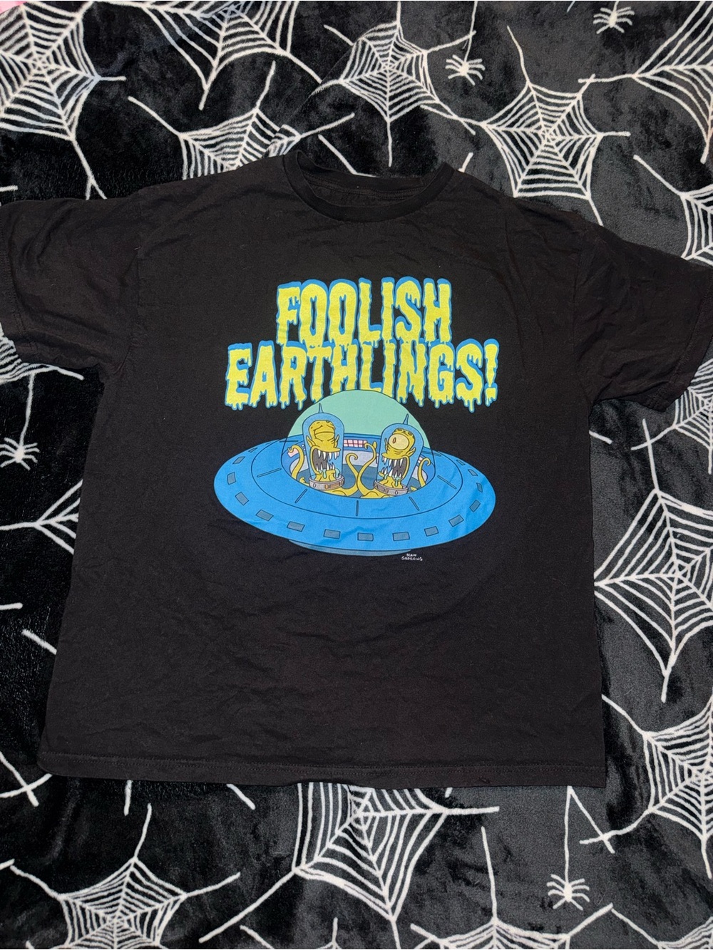 The Simpsons Foolish Earthlings black cotton t-shirt with blue UFO graphic